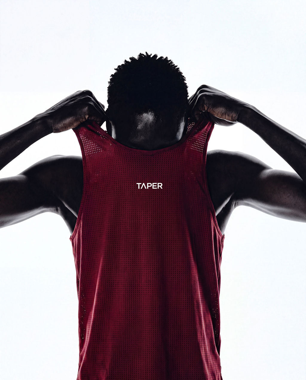 Taper Singlet by Taper in Burgundy — pulling on, back detail