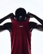 Taper Singlet by Taper in Burgundy — pulling on, back detail